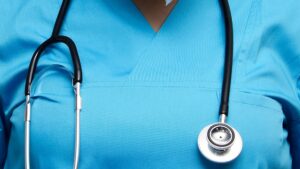 Health workers in the UK wearing blue medical scrubs